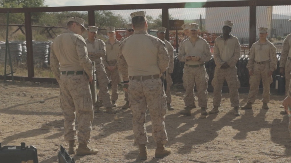 Service members in desert formation receiving a mission brief before a counter-UAS exercise