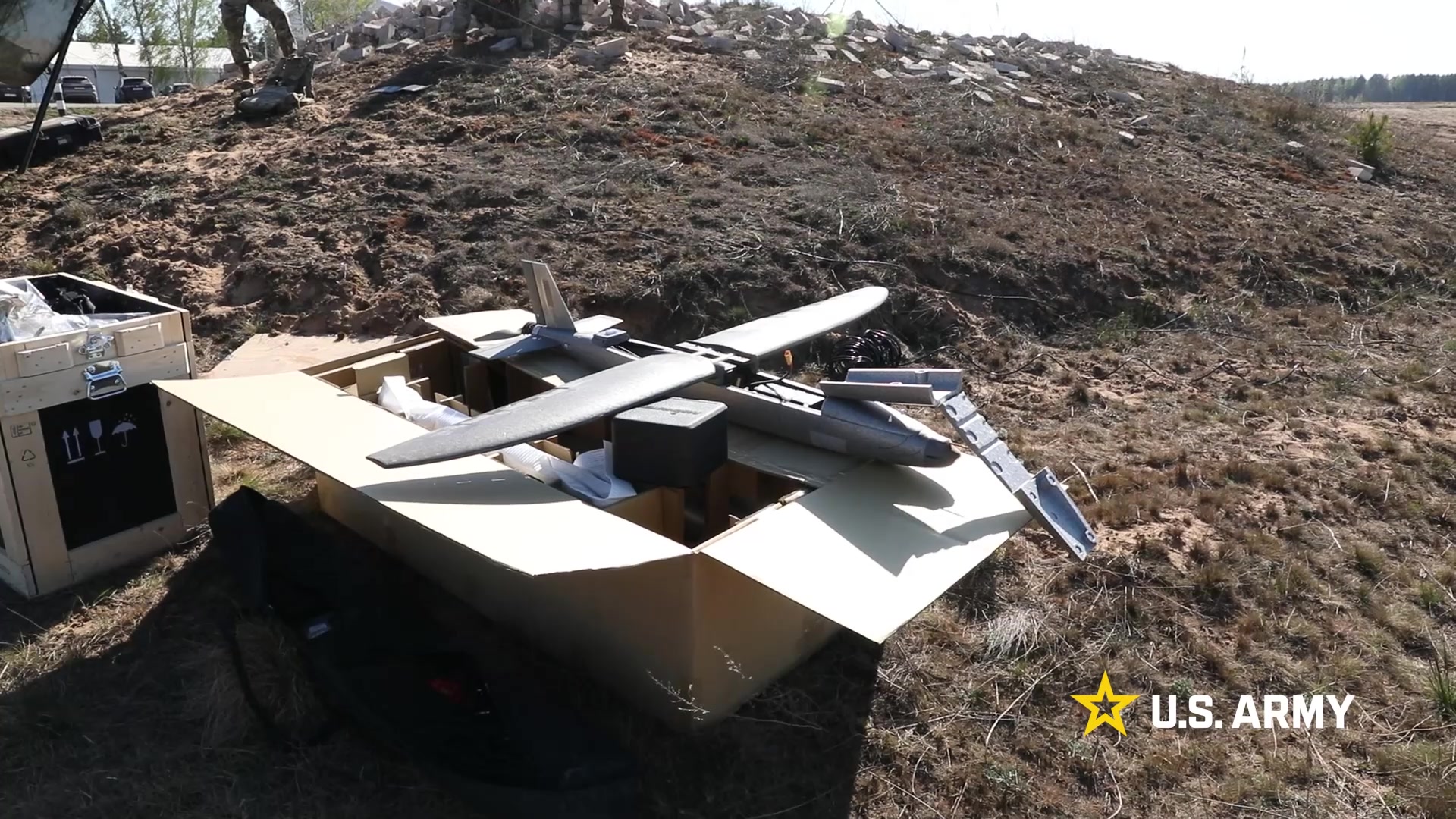 Soldiers inspecting counter-drone equipment on the range